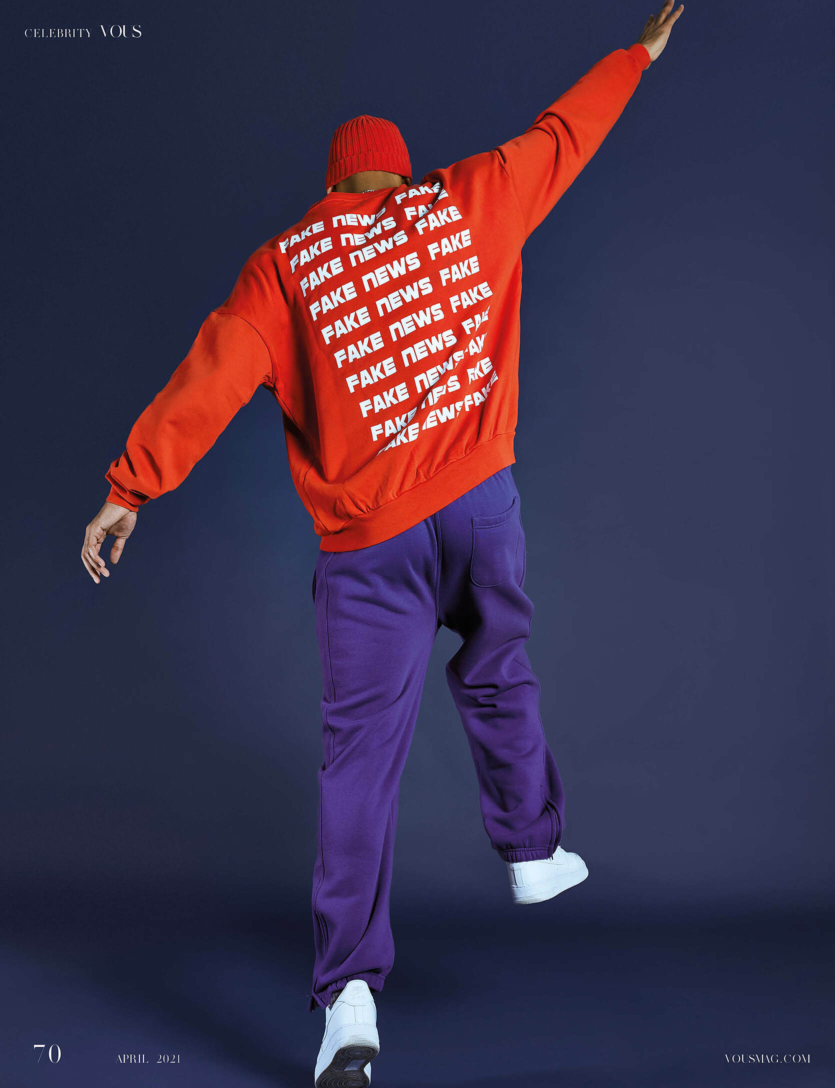 A male model with a red pullover and purple trousers