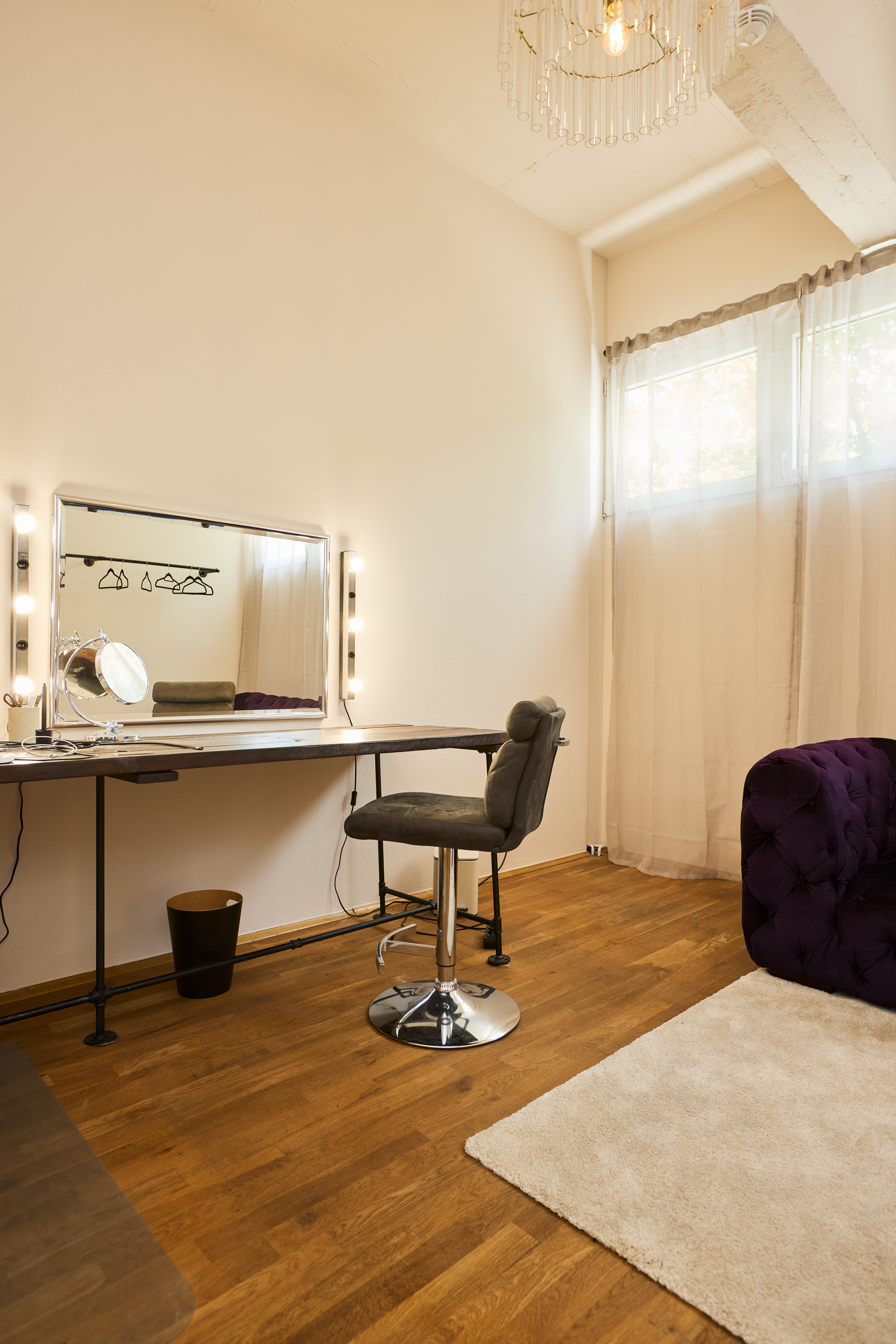 Close-up of the lighted vanity mirror with hanging clothes rail
