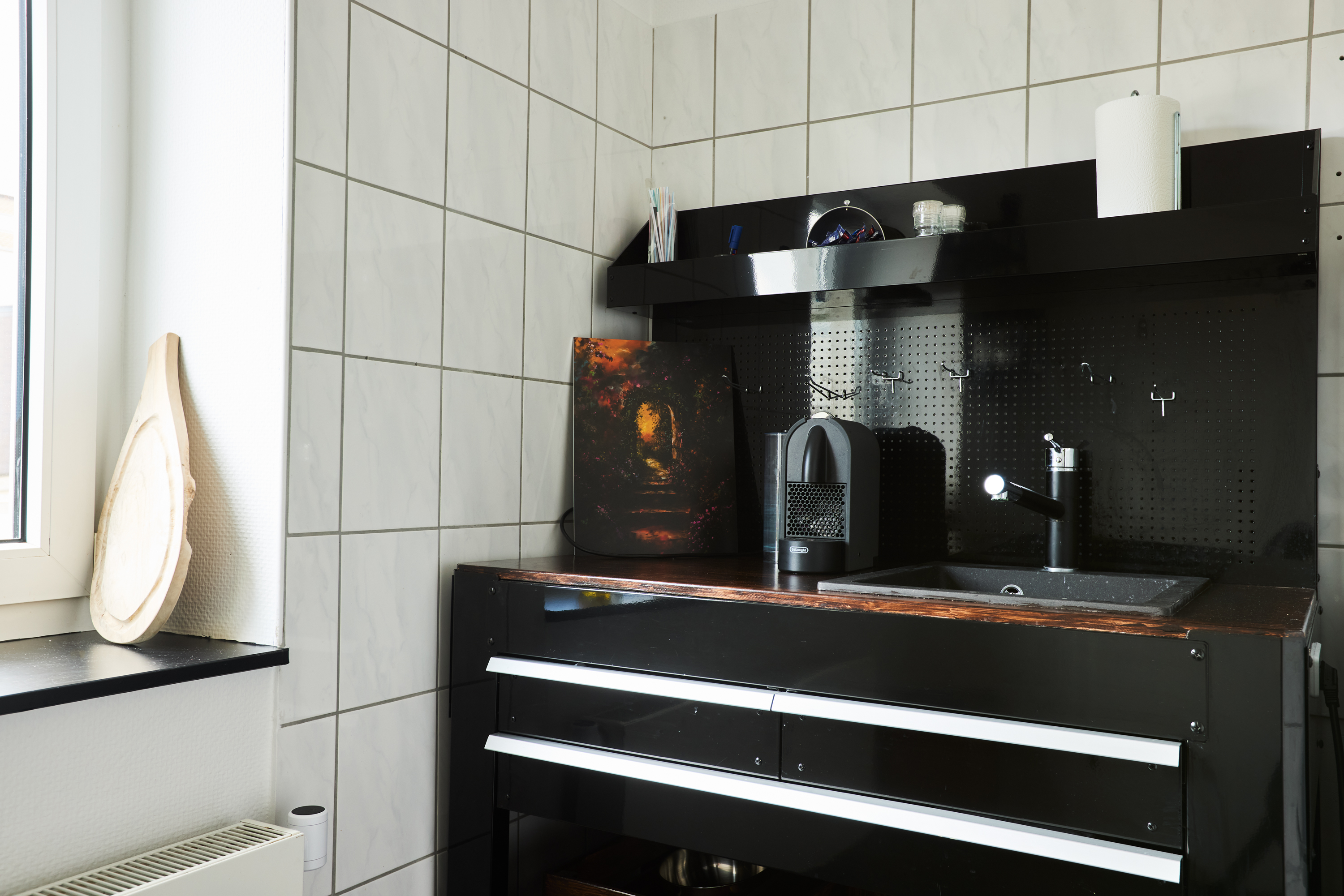 Kitchenette with sink, coffee machine and storage