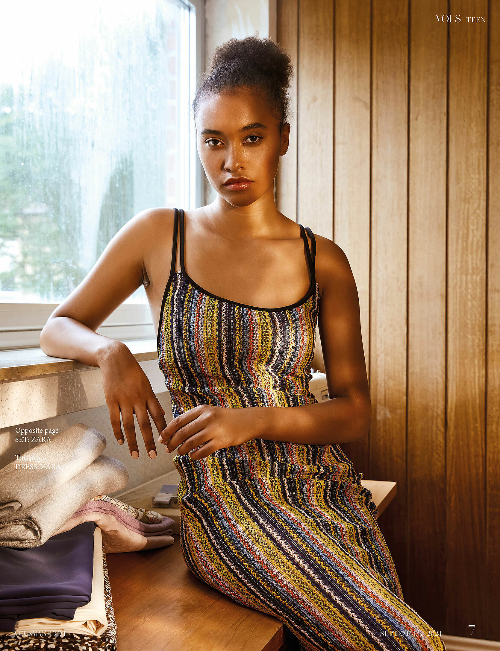  A model sits on the table in a long dress