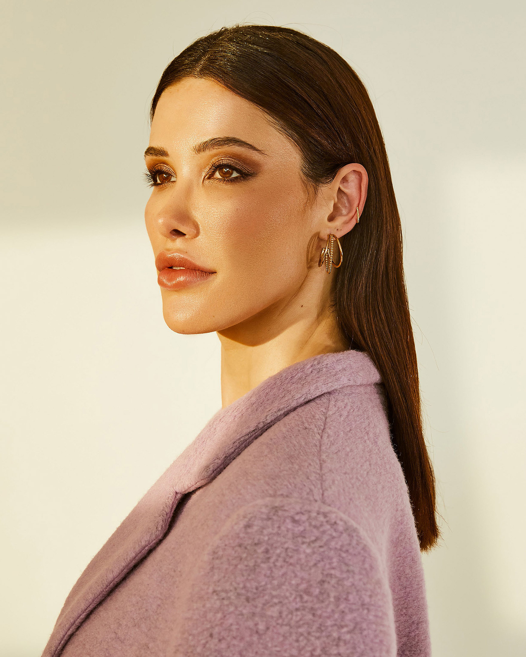 A portrait of the model in the lilac coat