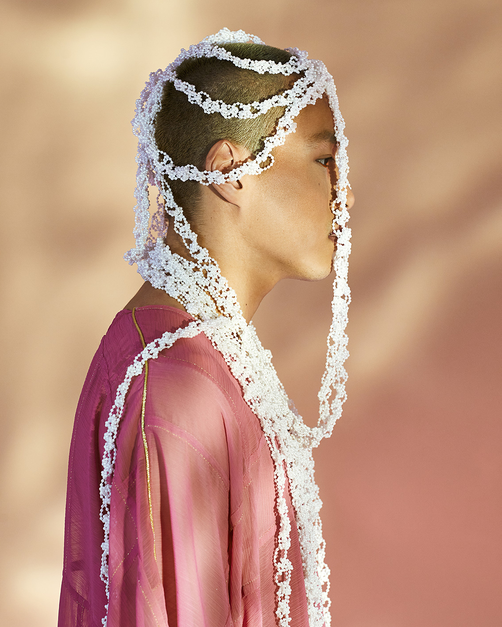 a portrait from a model with a white headpiece